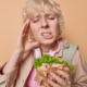 Child experiencing tooth pain while eating a sandwich, illustrating dental emergencies.