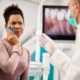 Patient holding cheek in pain during dental consultation with dentist in Jacksonville, NC office.