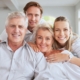 Happy multi-generational family smiling together in a bright home setting.