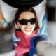 Patient smiling while receiving professional teeth whitening treatment with protective eyewear.