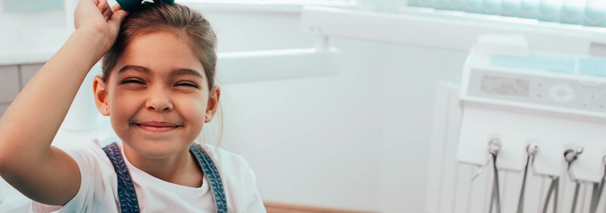 Happy child holding colorful toy in Jacksonville pediatric dental office.