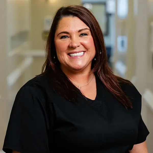 img-megan-cox Team member smiling in professional dental office setting in Jacksonville, NC.