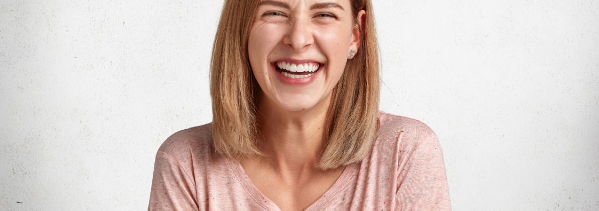 Woman smiling while considering clear aligner treatment in Jacksonville, NC