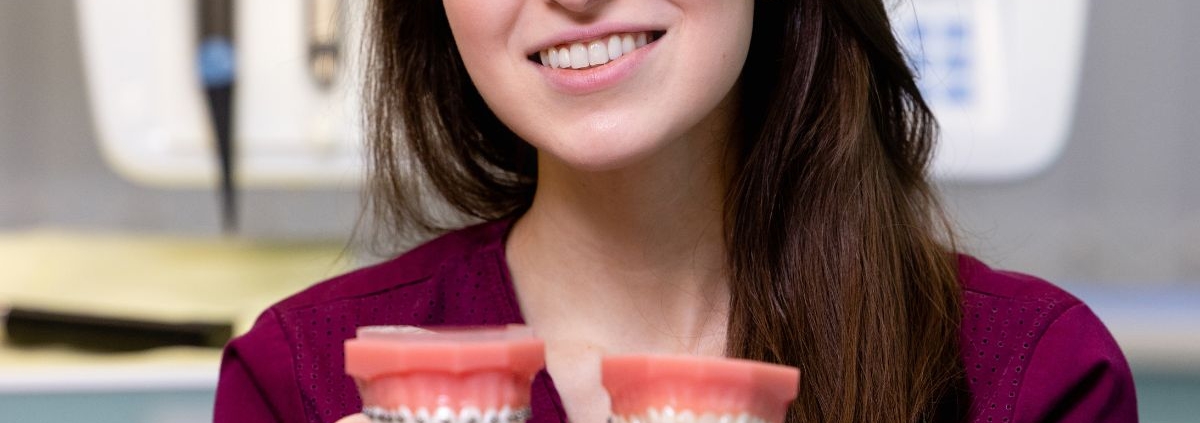 Woman comparing traditional braces with orthodontic treatment options in Jacksonville, NC